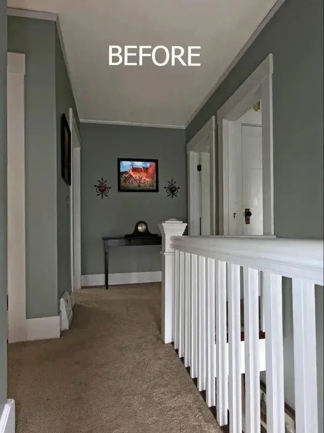 Upstairs hallway with a white railing looking dim before a tubular skylight was installed