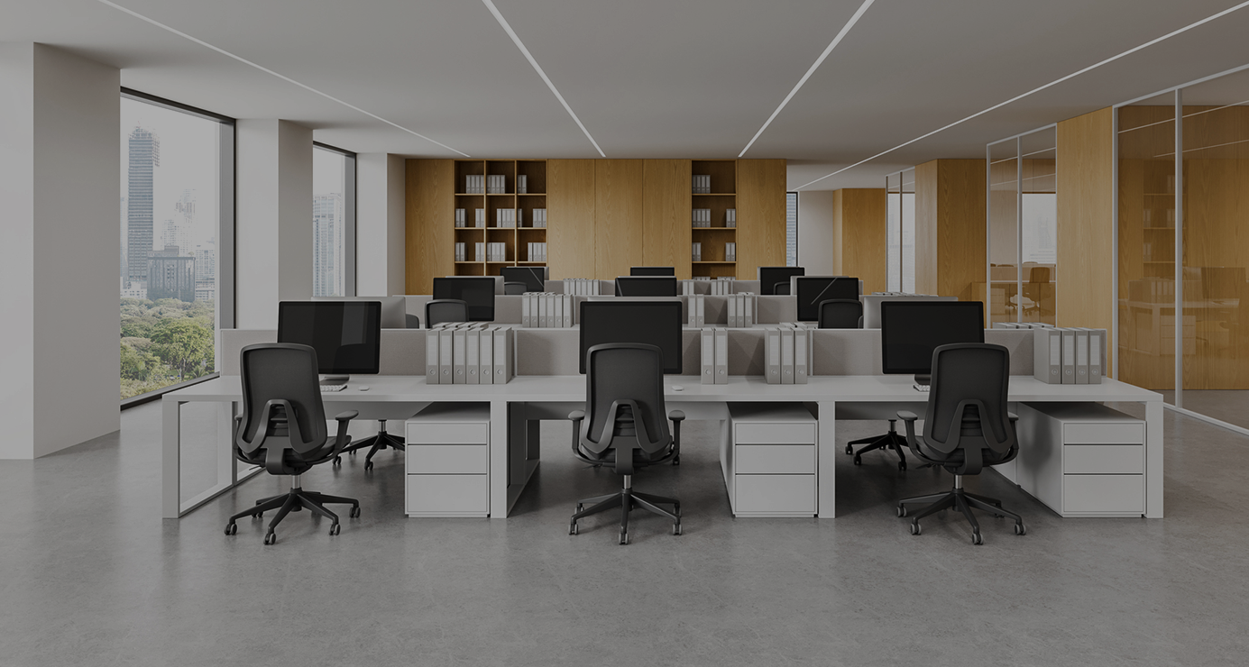 The same open-plan office looking dim before a tubular skylight was installed